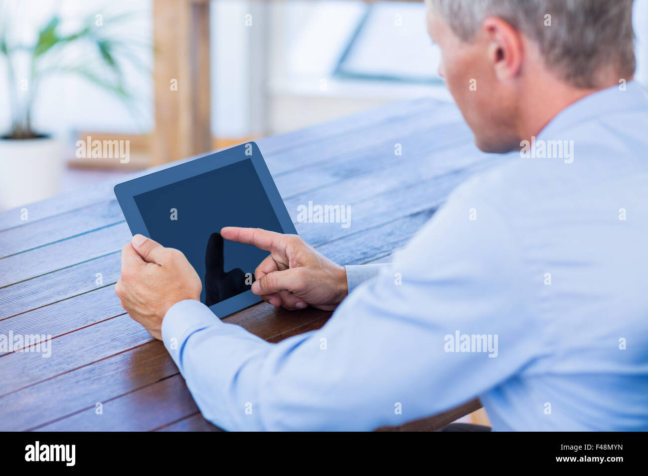 Serious businessman using tablet computer Stock Photo