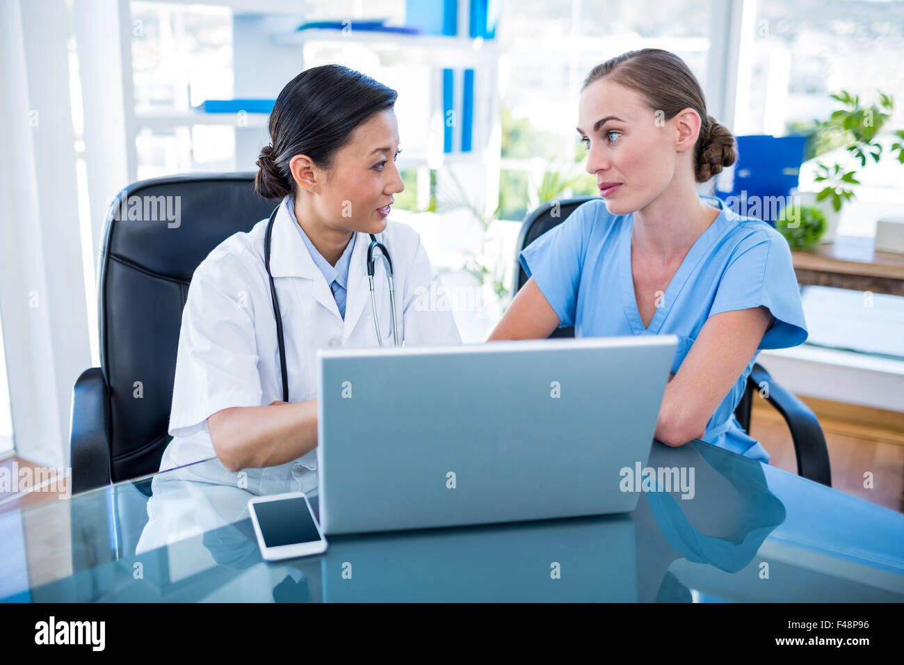 Doctor nurse looking laptop hi-res stock photography and images - Alamy