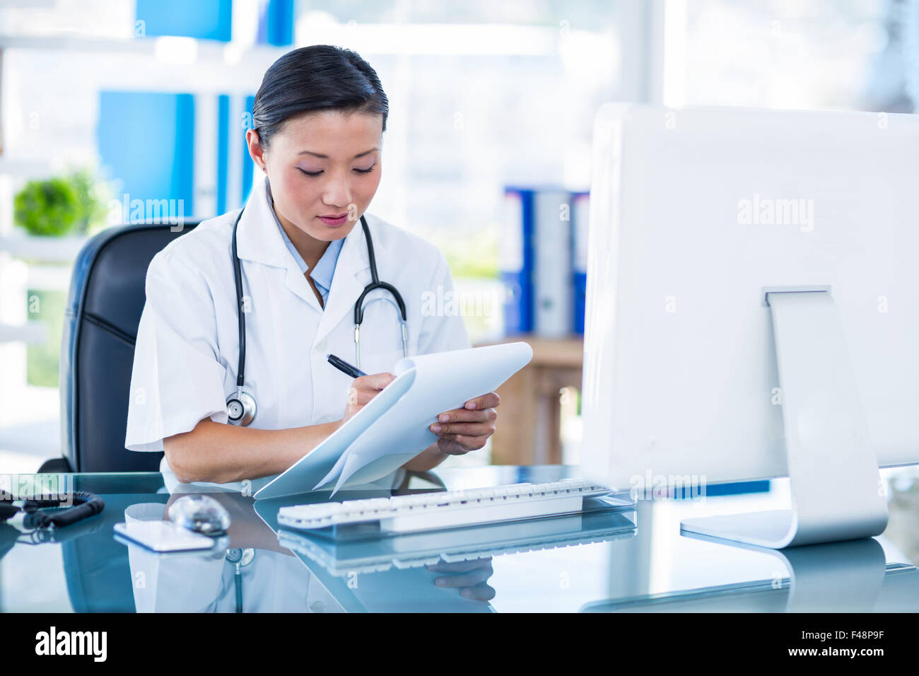 Focused female doctor writing hi-res stock photography and images - Alamy
