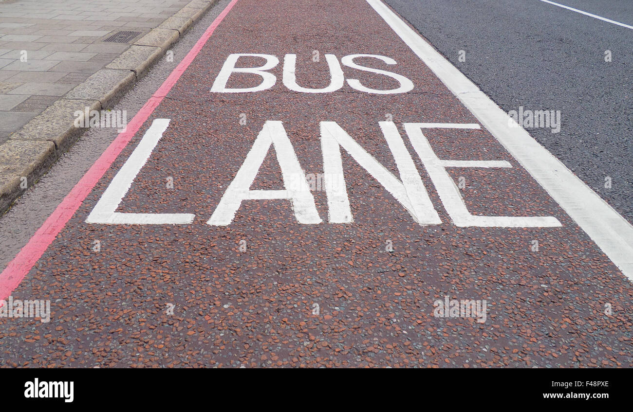 Traffic signs indicating lane reserved to buses and public transport means on a London street Stock Photo