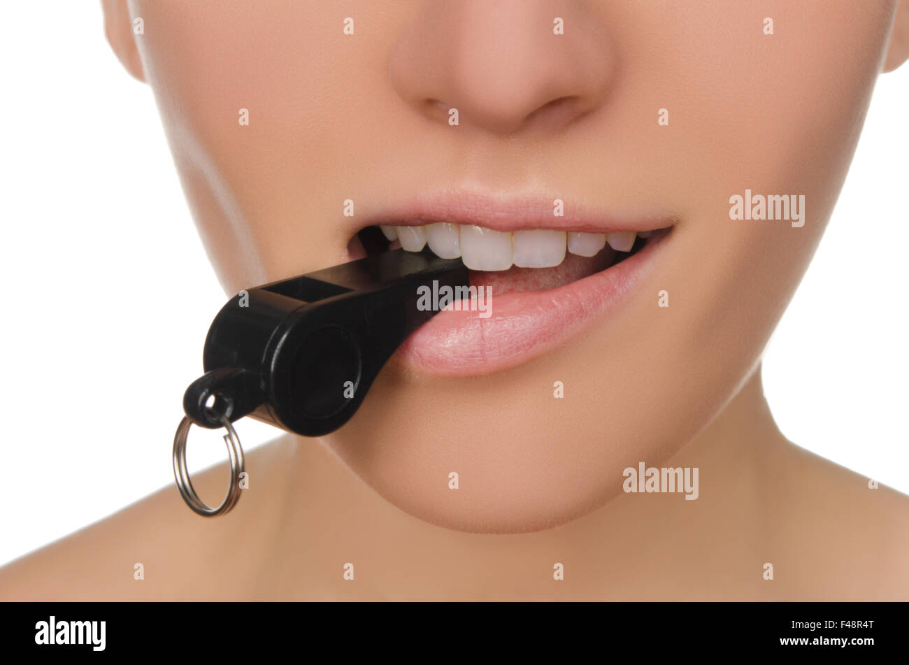 woman holding whistle in his mouth closeup Stock Photo