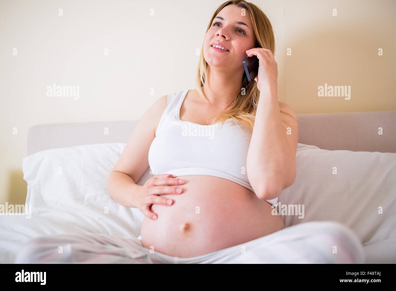 Pregnant woman having phone call Stock Photo