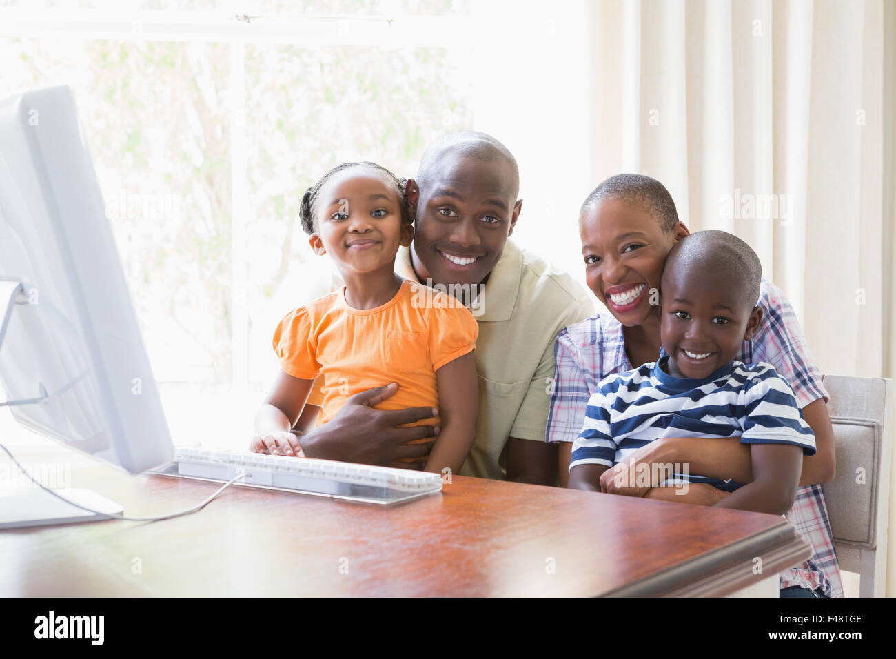 Portrait happy smiling family using computer Stock Photo - Alamy