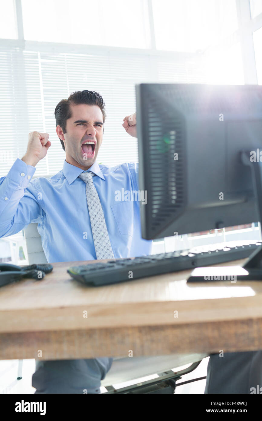 Businessman cheering at office desk hi-res stock photography and images ...