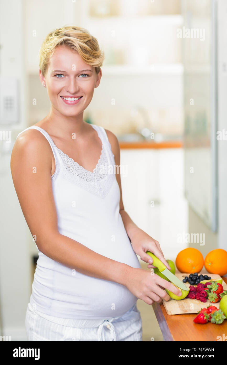 Pregnant woman cutting fruits on the cutting board Stock Photo Alamy