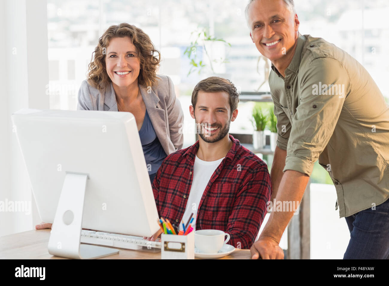 Creative business people smiling at camera Stock Photo - Alamy