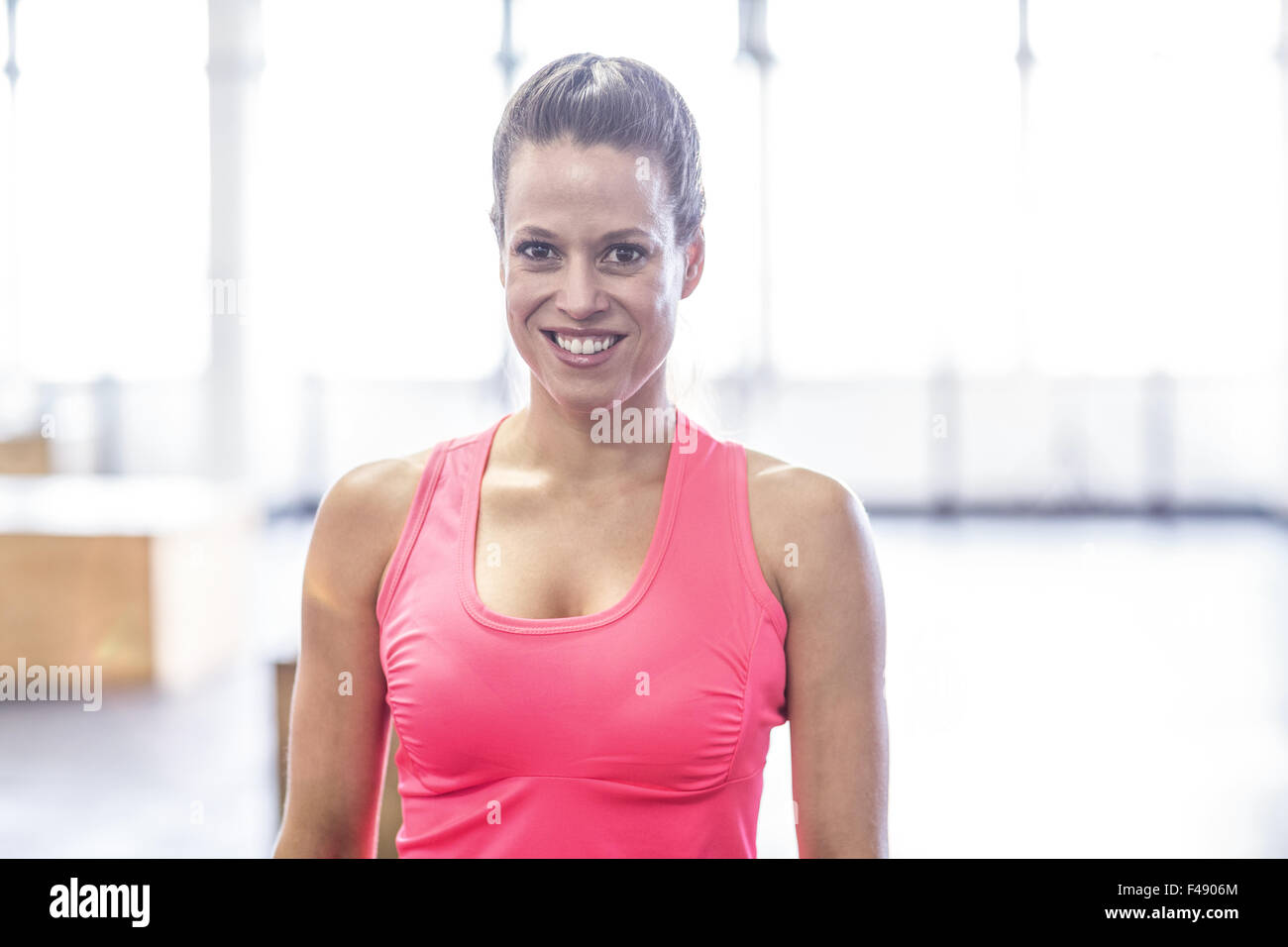 Smiling woman posing in crossfit gym Stock Photo