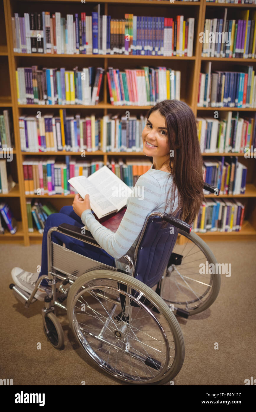 Disabled female student with book Stock Photo