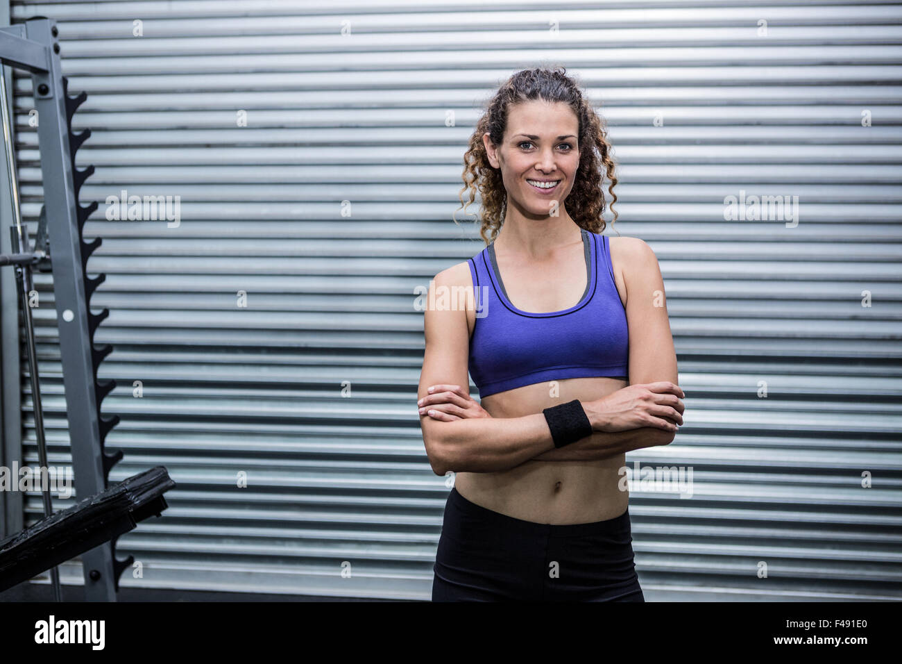 Smiling muscular woman arms crossed hi-res stock photography and