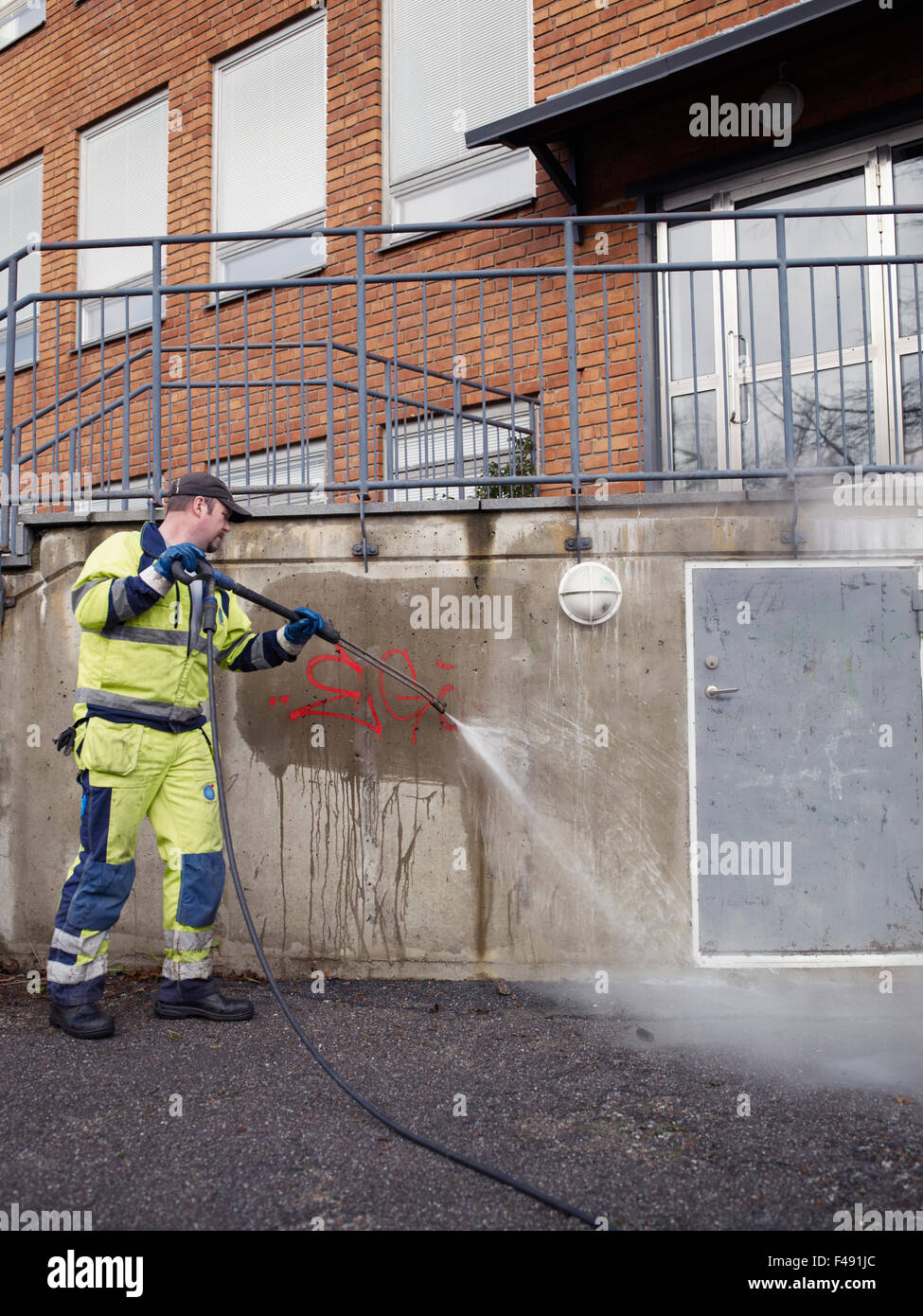 A man removing graffiti, Sweden. Stock Photo