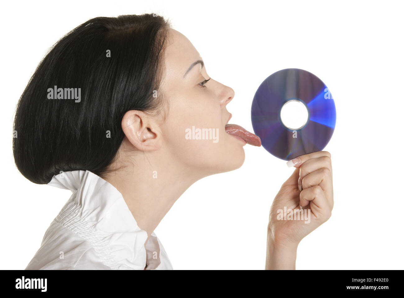 Young woman licks optical disk Stock Photo