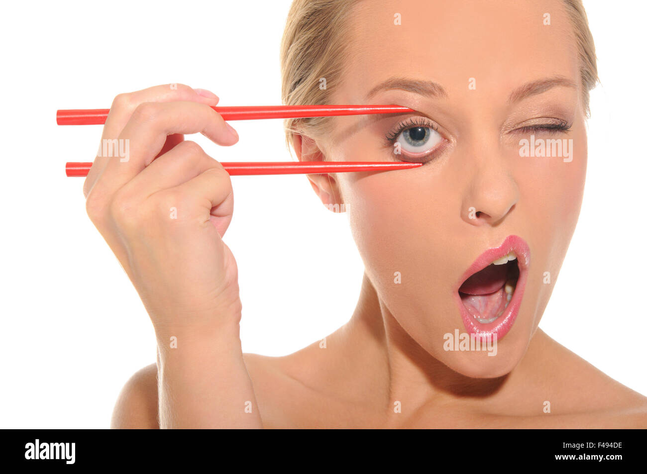 Surprised woman opens her eyes chopsticks Stock Photo