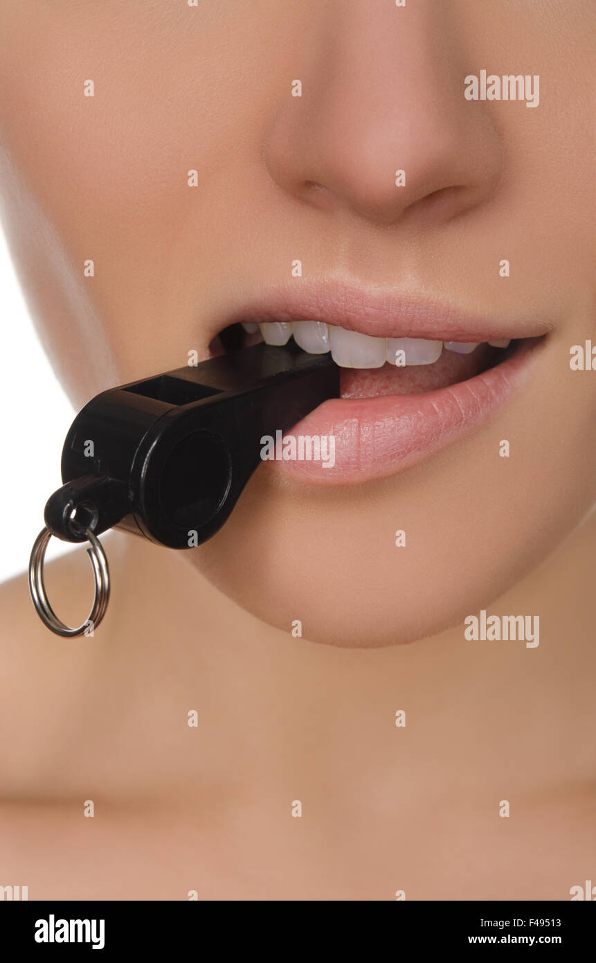 woman holding whistle in his mouth closeup Stock Photo