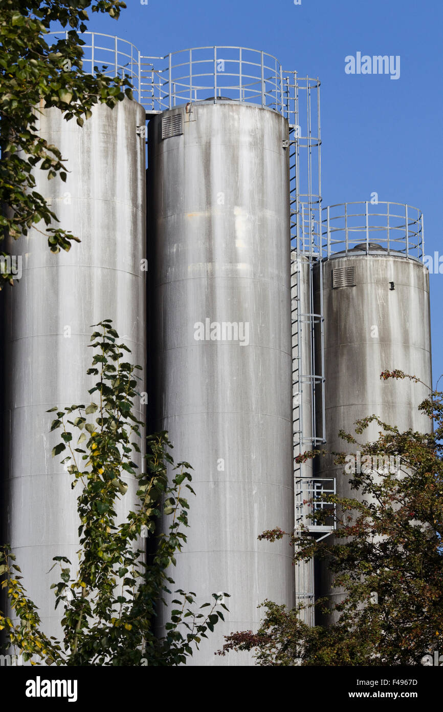 Giant silos with ladders against a blue sky hi-res stock photography