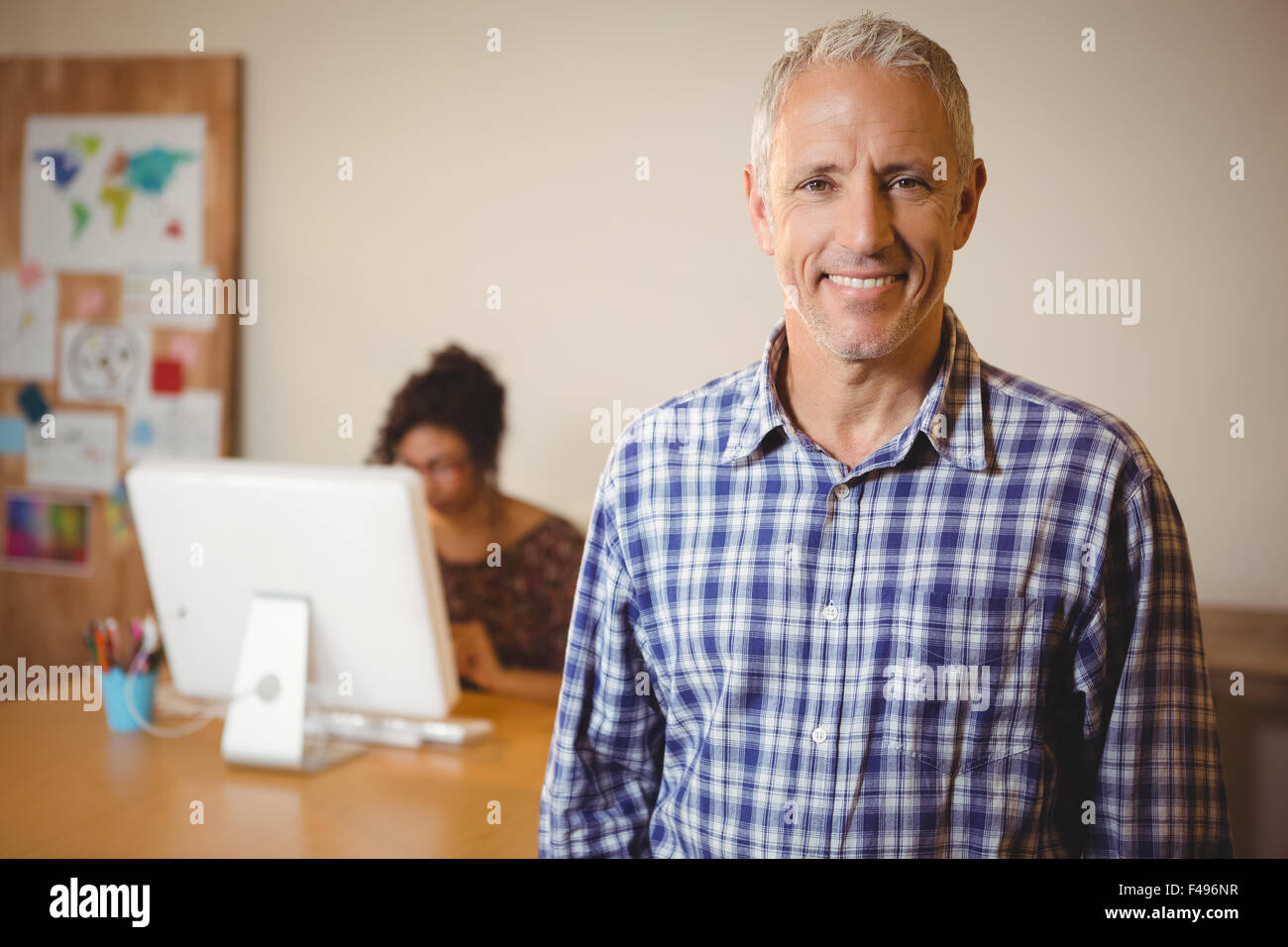 Portrait of creative businessman smiling in office Stock Photo - Alamy