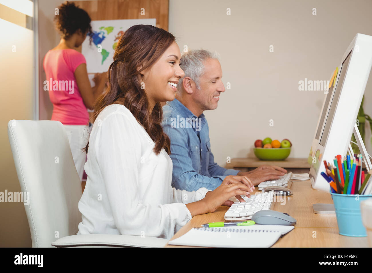 Business people working on computer at desk in office Stock Photo