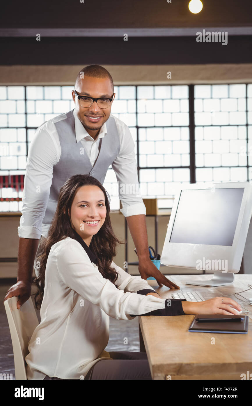 Portrait of smiling man and woman at office desk Stock Photo - Alamy