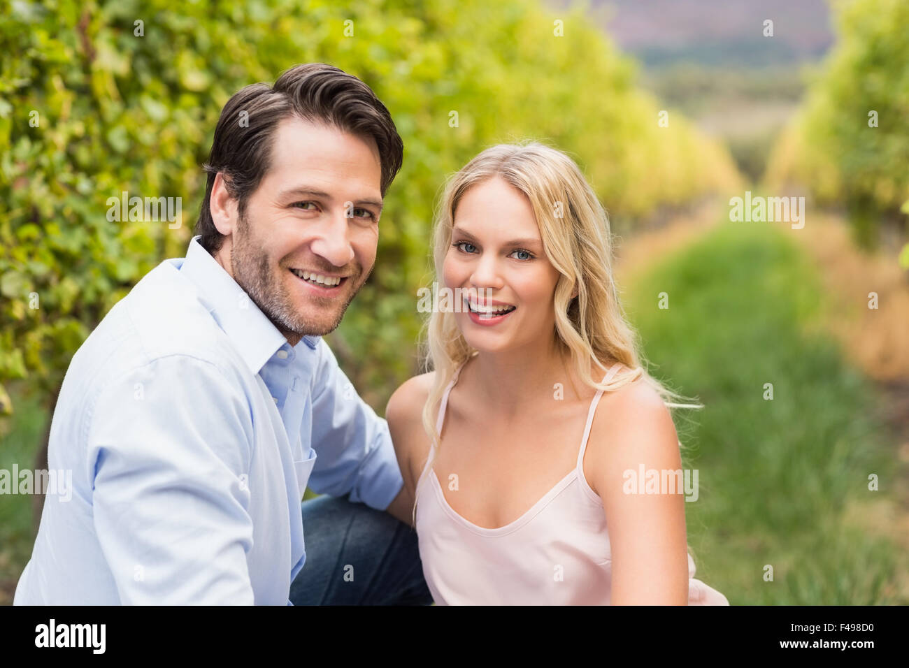 Young happy couple smiling at camera Stock Photo - Alamy