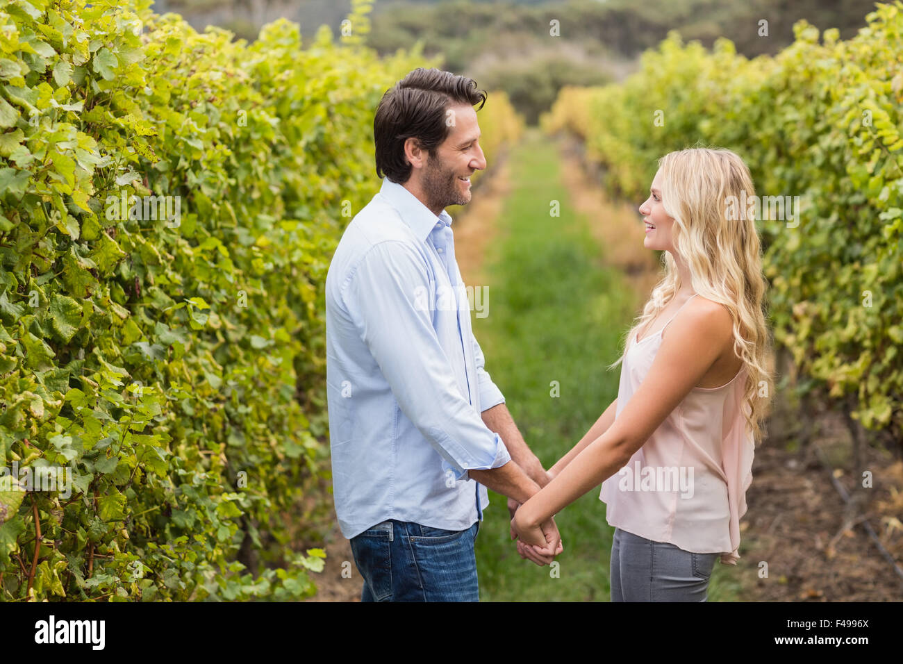 Young happy couple holding hands Stock Photo - Alamy