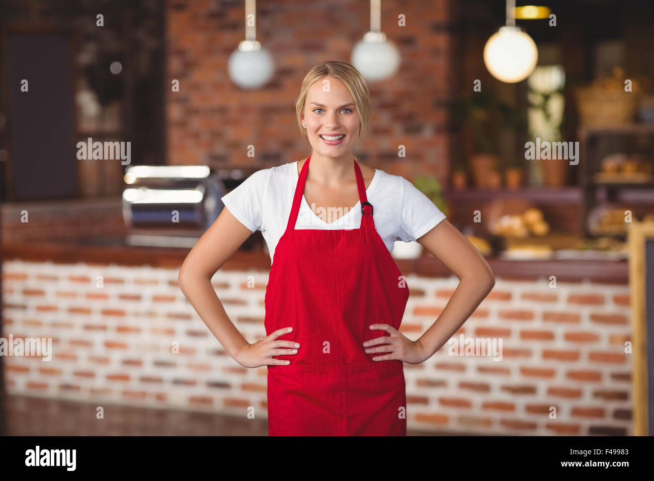 Pretty waitress with hands on hips Stock Photo