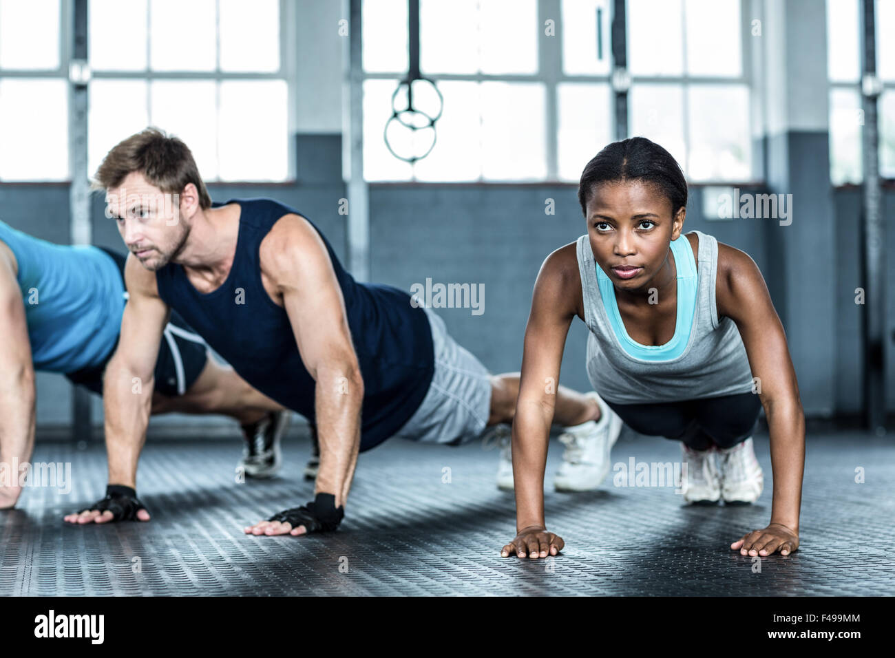 Fit people doing push up together Stock Photo