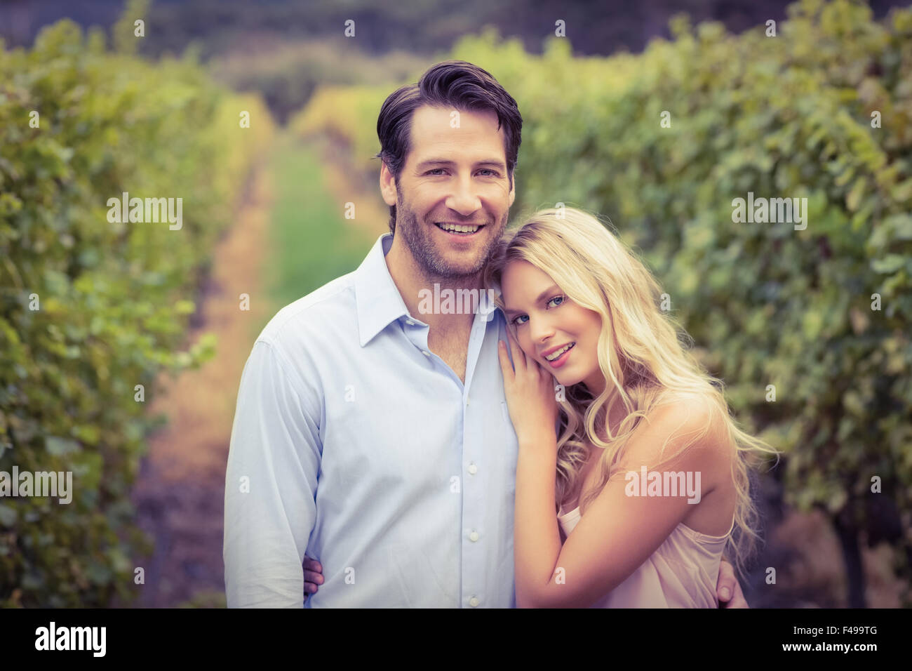 Young happy couple smiling at camera Stock Photo - Alamy
