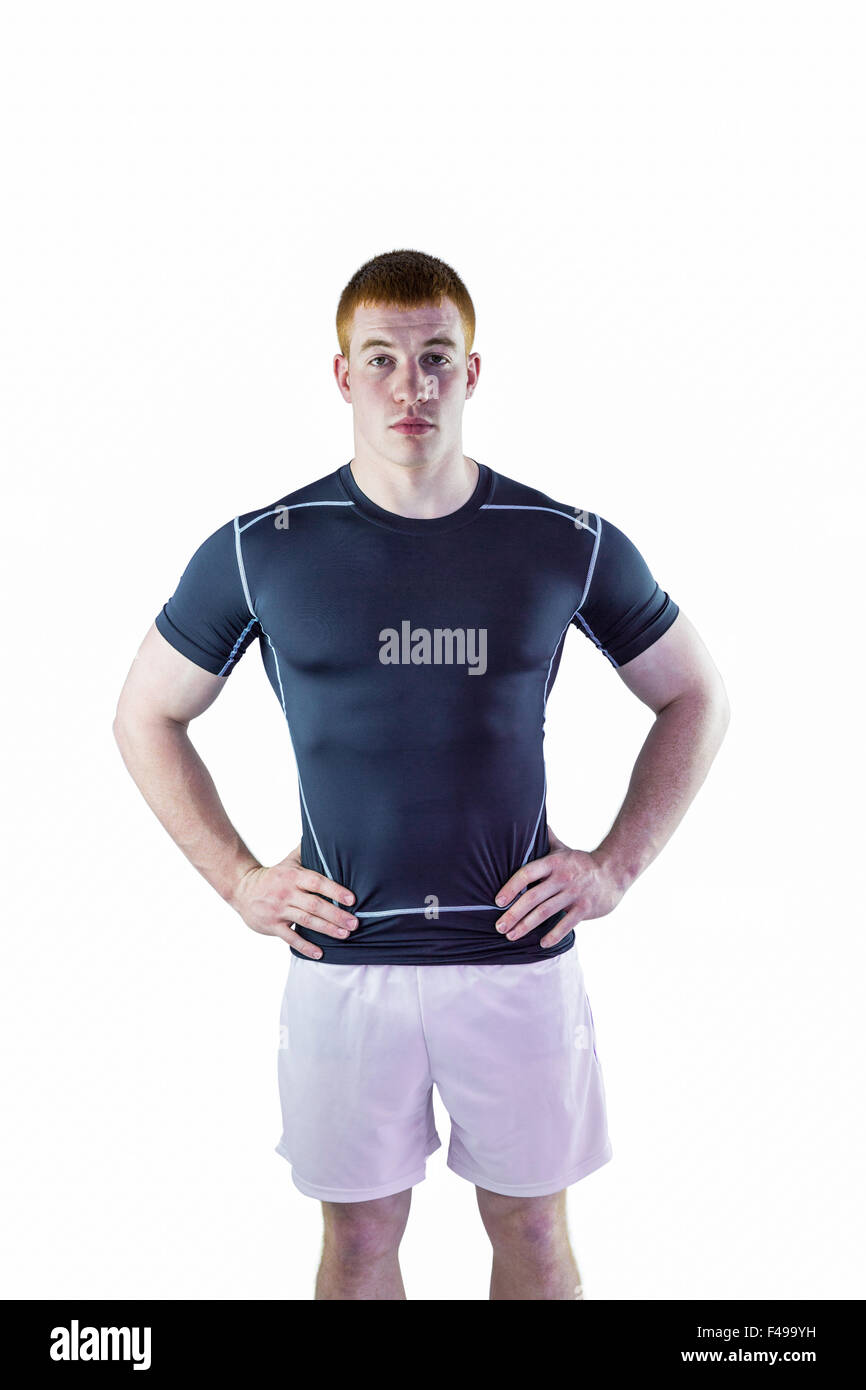 Muscular rugby player with hands on hips Stock Photo