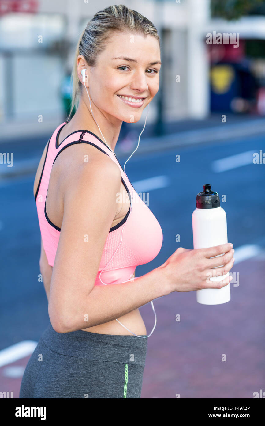 A beautiful woman holding a bottle of water Stock Photo - Alamy