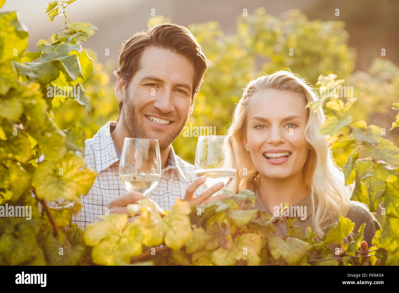 Young happy couple holding glasses of wine Stock Photo - Alamy