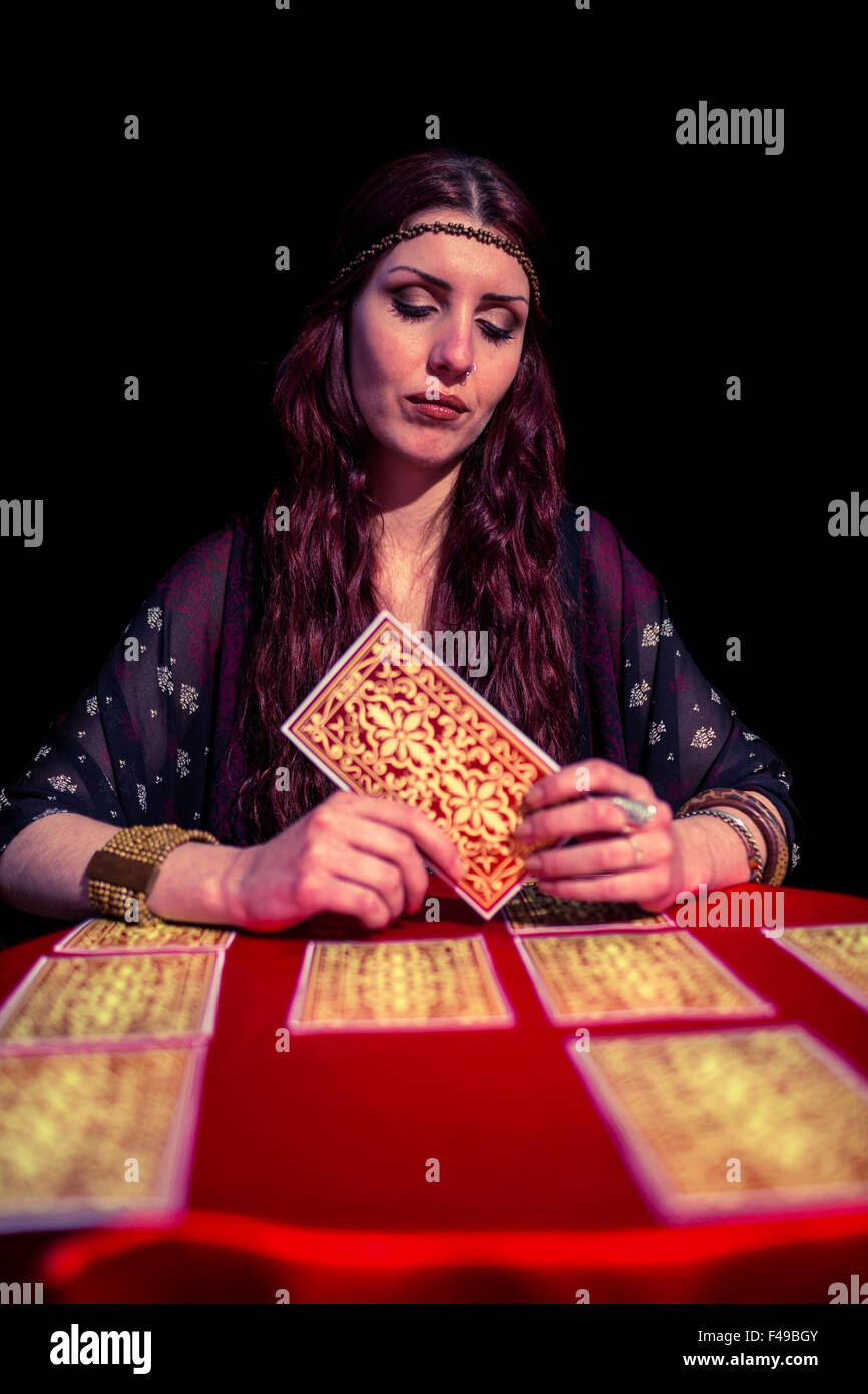 Female fortune teller using tarot cards with eyes closed Stock Photo