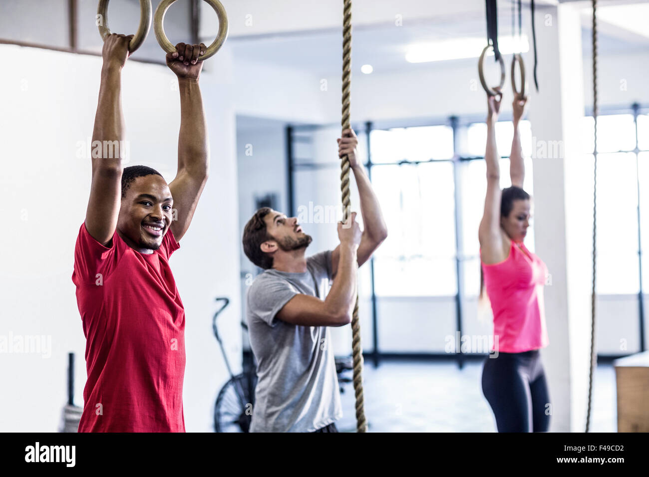 Athletes doing ring gymnastics and climbing rope Stock Photo Alamy