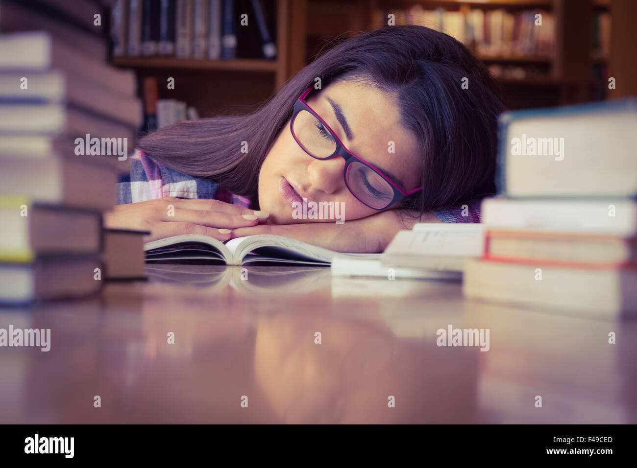 Female student sleeping with head on book Stock Photo