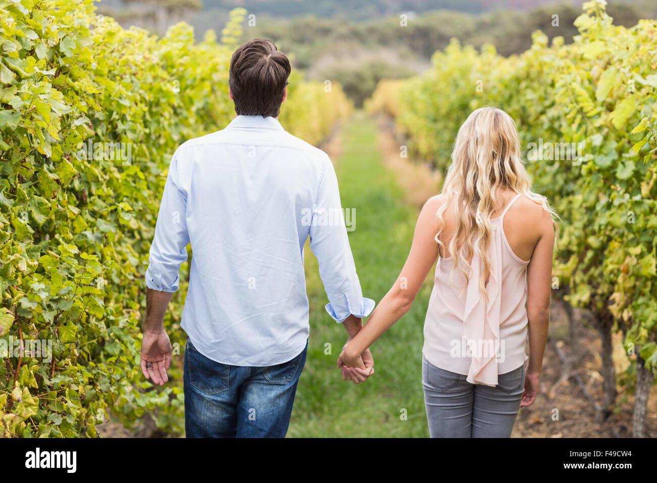 Young happy couple holding hands Stock Photo - Alamy
