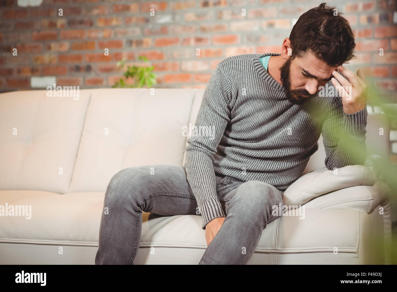 Stressed man holding his forehead Stock Photo