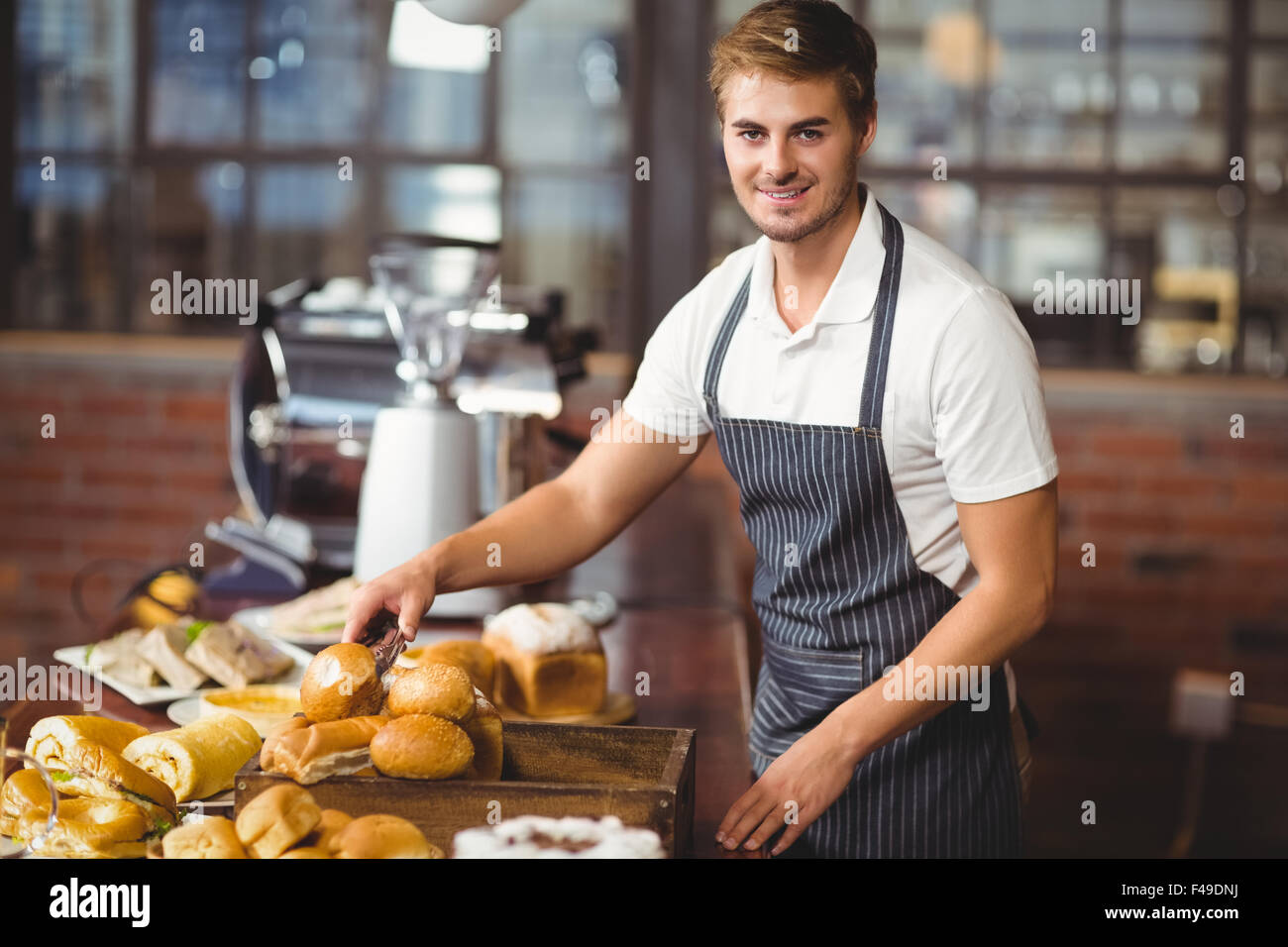 Serving Pickers Handsome waiter picking up a roll Stock Photo - Alamy