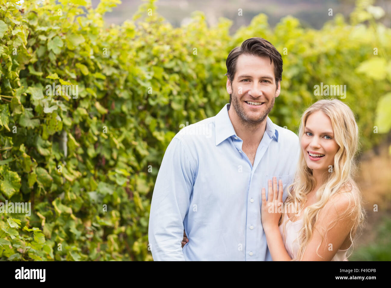 Young happy couple smiling at camera Stock Photo - Alamy