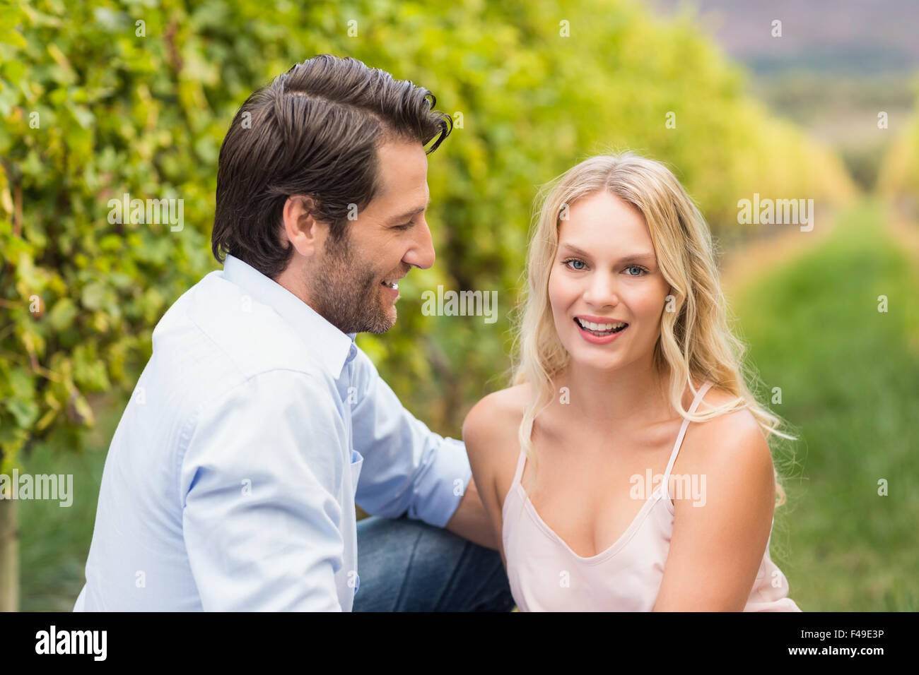 Young happy couple smiling at camera Stock Photo - Alamy
