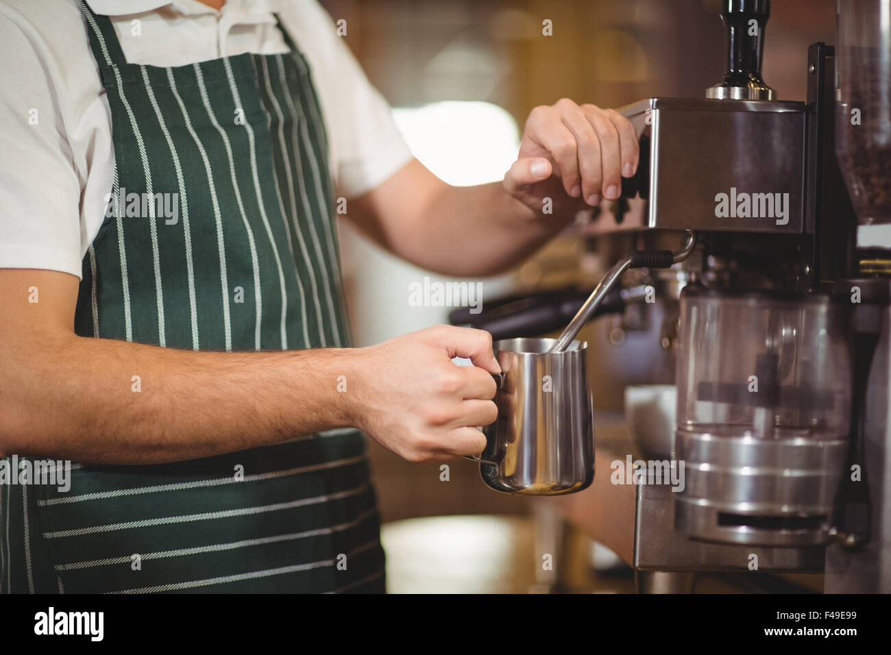Barista steaming milk at the coffee machine Stock Photo Alamy