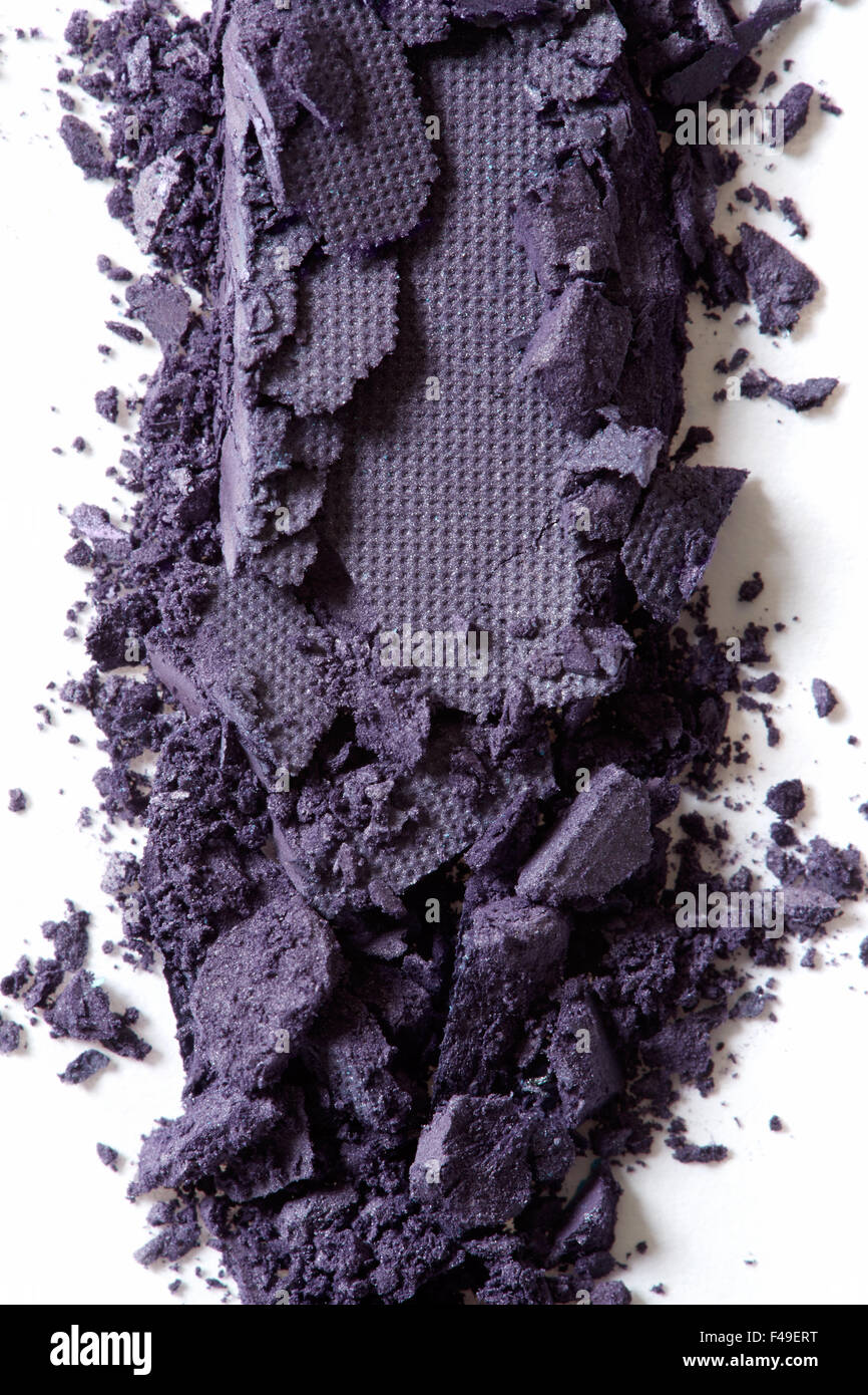 Dark purple eye shadow crushed cosmetic macro background Stock Photo