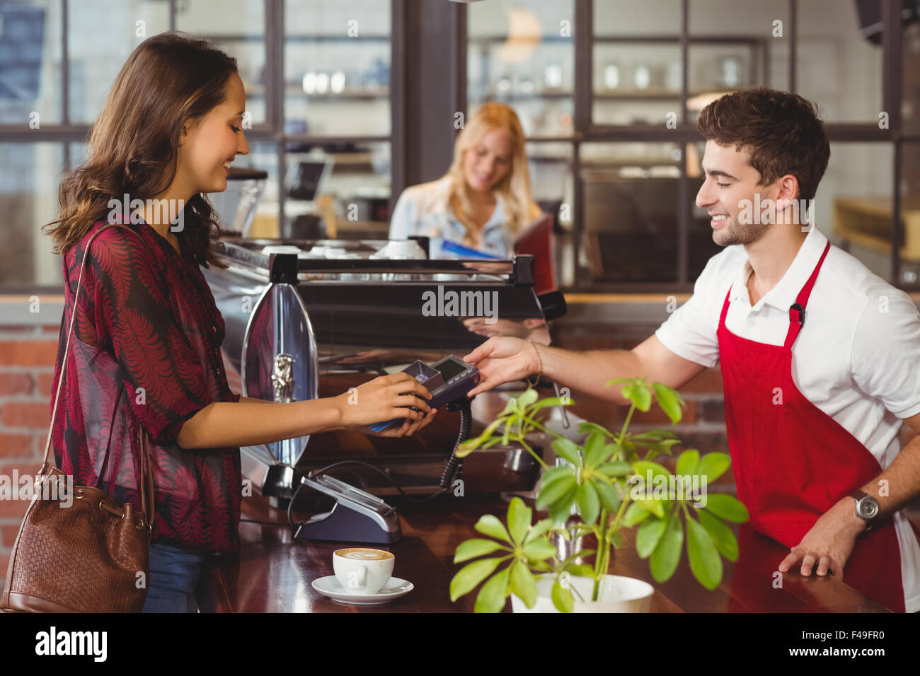 Smiling Waiter Handing A Pin Terminal Stock Photo Alamy Smiling Waiter Handing A Pin Terminal Stock Photo Alamy