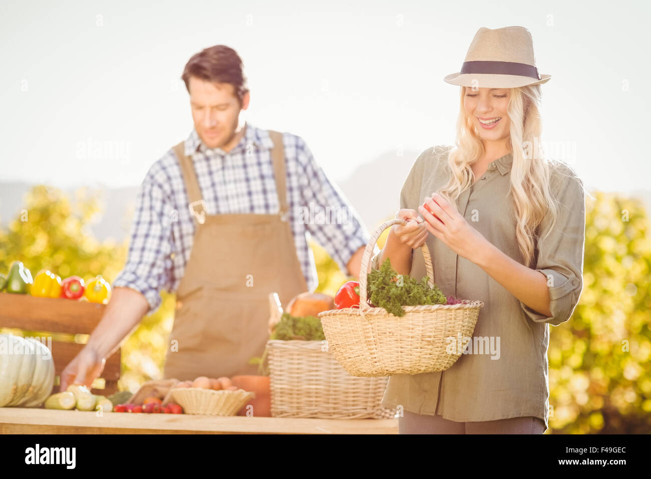 Blonde customer holding a vegetables basket Stock Photo - Alamy