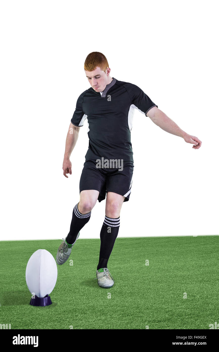 Rugby player doing a drop kick Stock Photo - Alamy