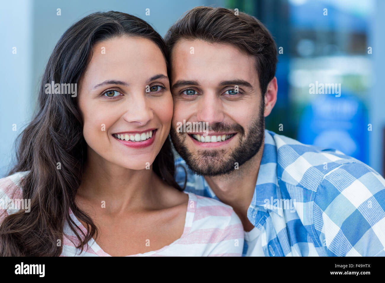 Young happy couple smiling at the camera Stock Photo - Alamy