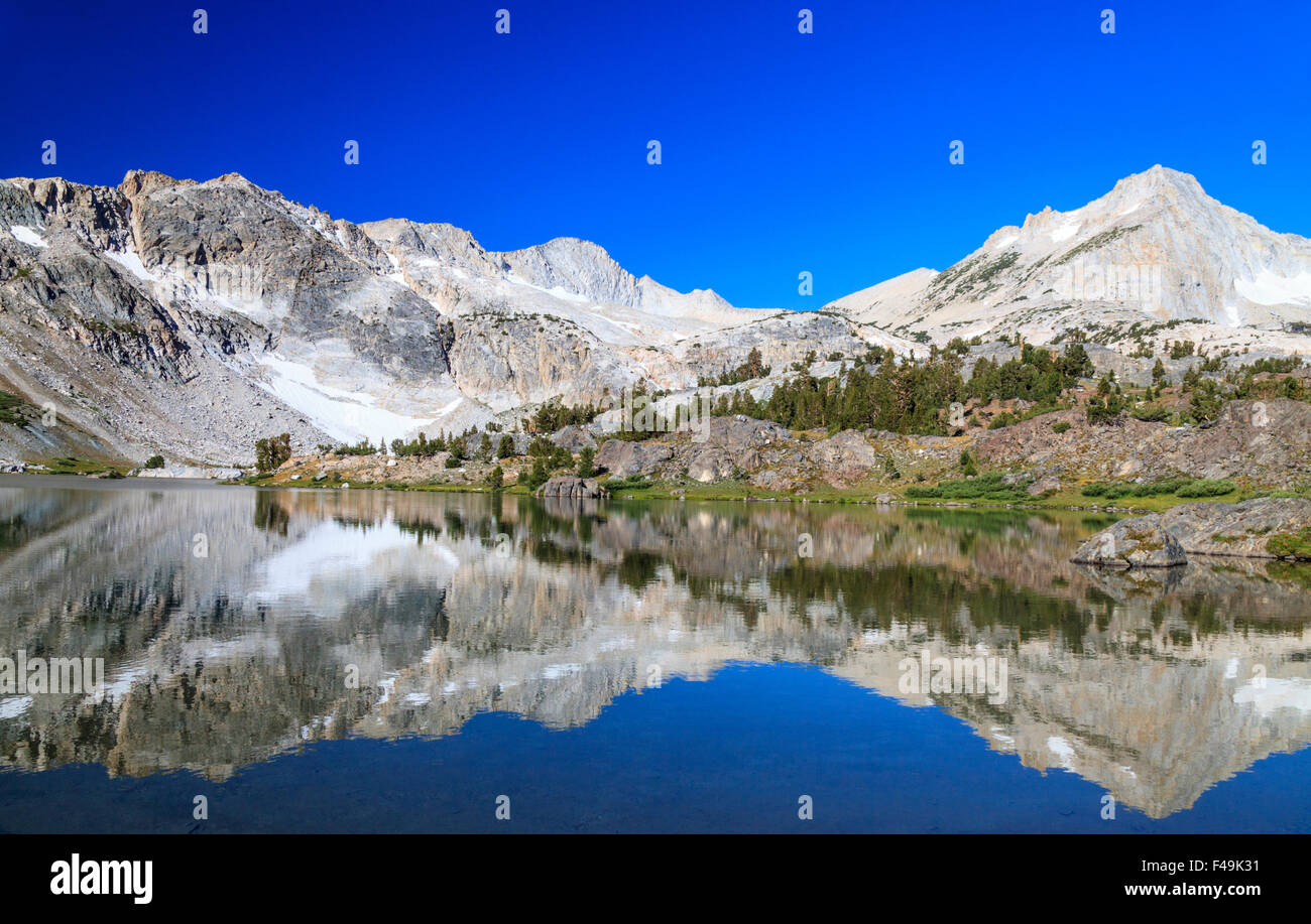 Mirror reflection in Greenstone Lake at 20 Lakes Basin in the Eastern Sierra in Northern California Stock Photo