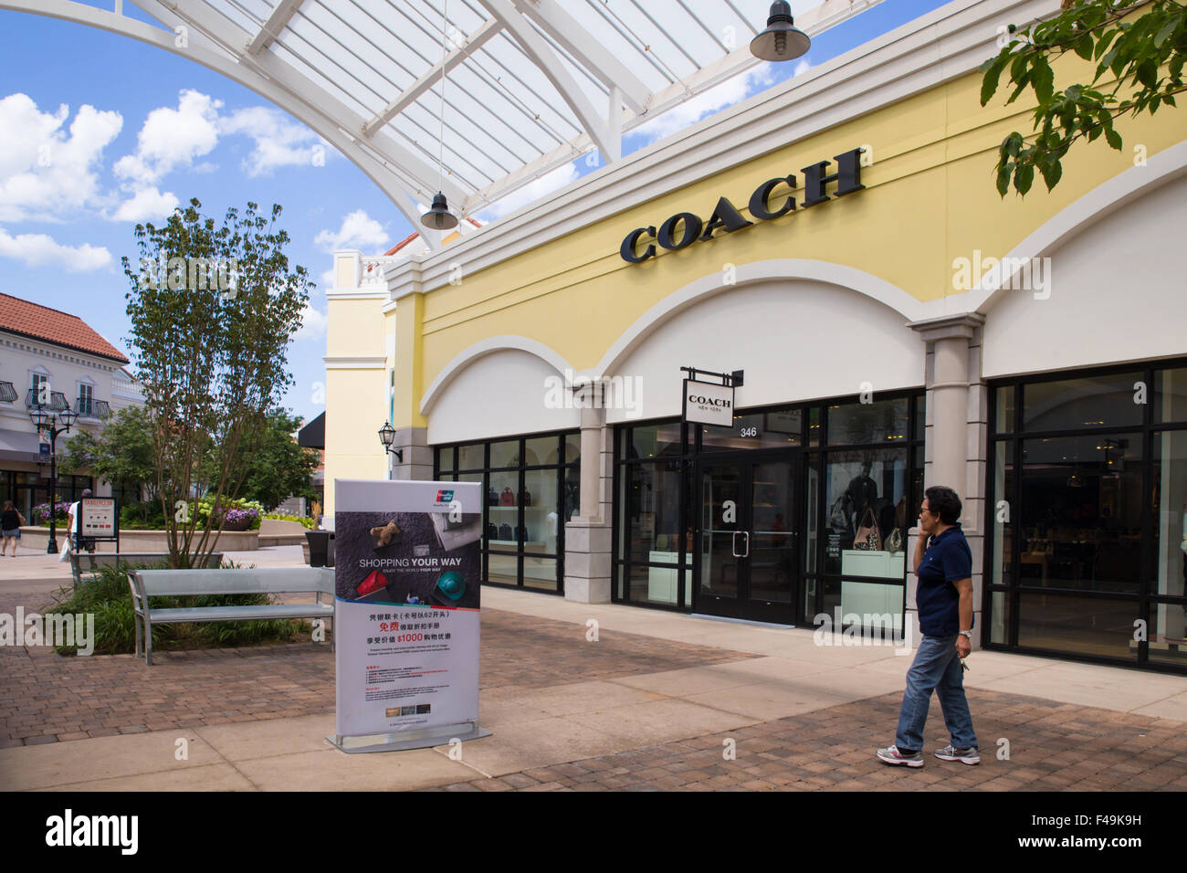 View of Tanger Factory Outlet outdoor shopping mall near the with people visible. Stock Photo