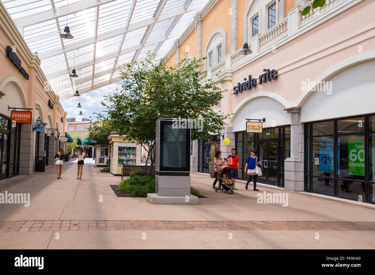 View of Tanger Factory Outlet outdoor shopping mall near the with people visible. Stock Photo