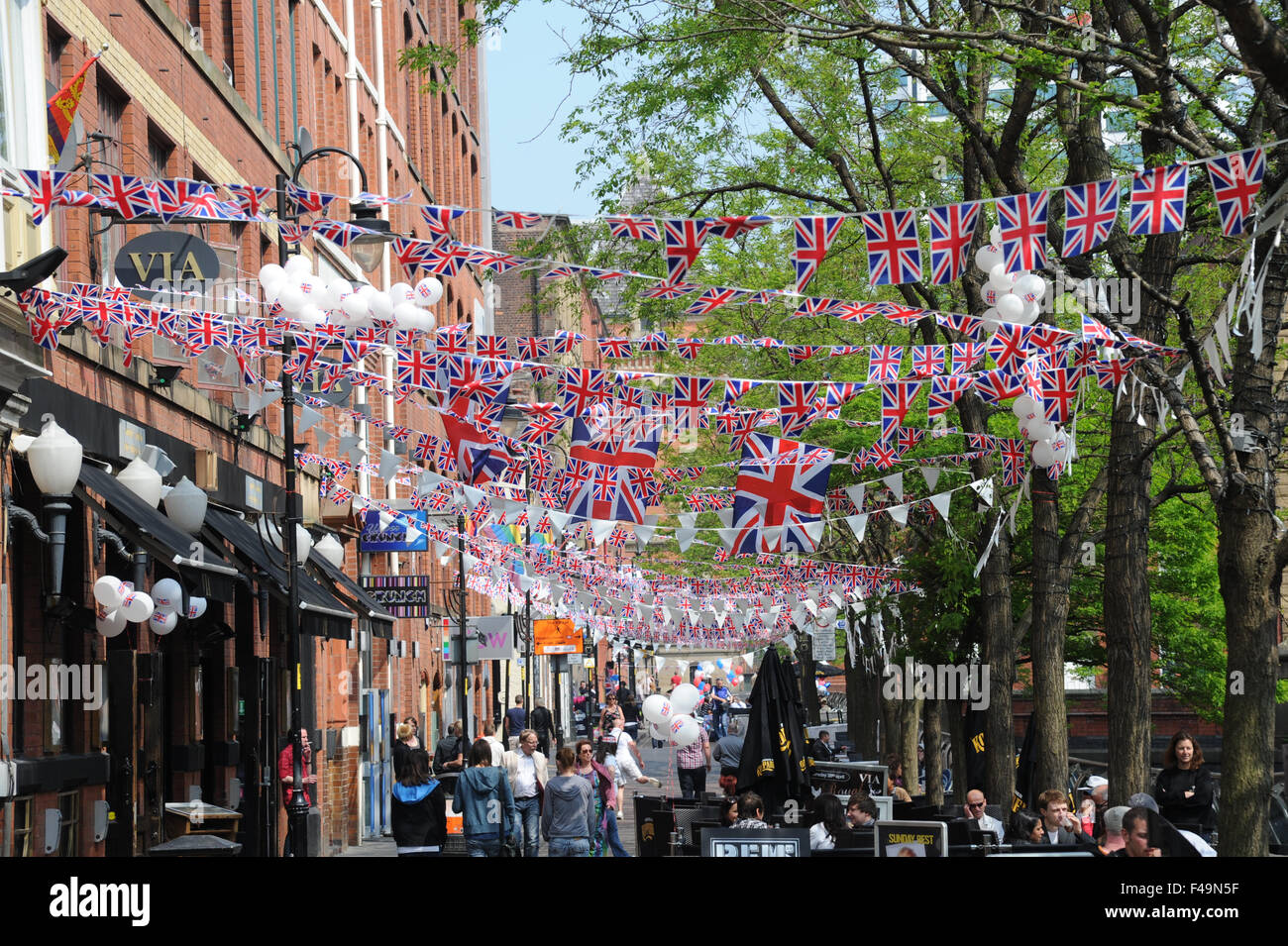 Party bunting on Canal Street in the heart of Manchester's Gay village to celebrate the wedding of William and Kate. Stock Photo