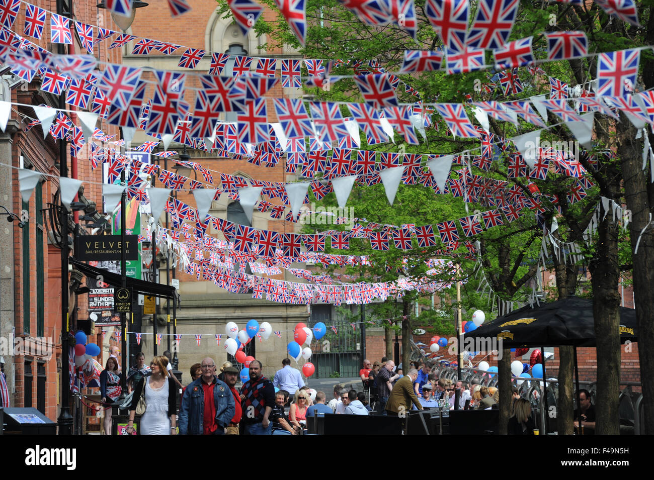 Party bunting on Canal Street in the heart of Manchester's Gay village to celebrate the wedding of William and Kate. Stock Photo