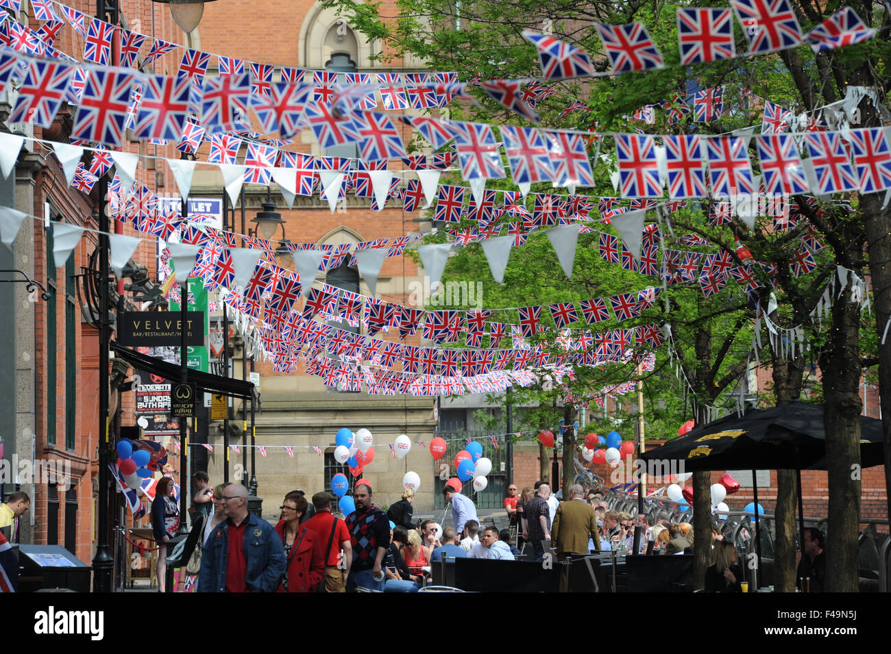 Party bunting on Canal Street in the heart of Manchester's Gay village to celebrate the wedding of William and Kate. Stock Photo