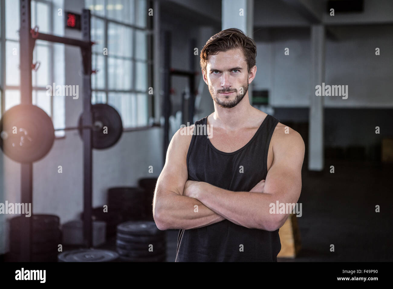 Muscular man keeping arms crossed Stock Photo by ©gstockstudio 75617291